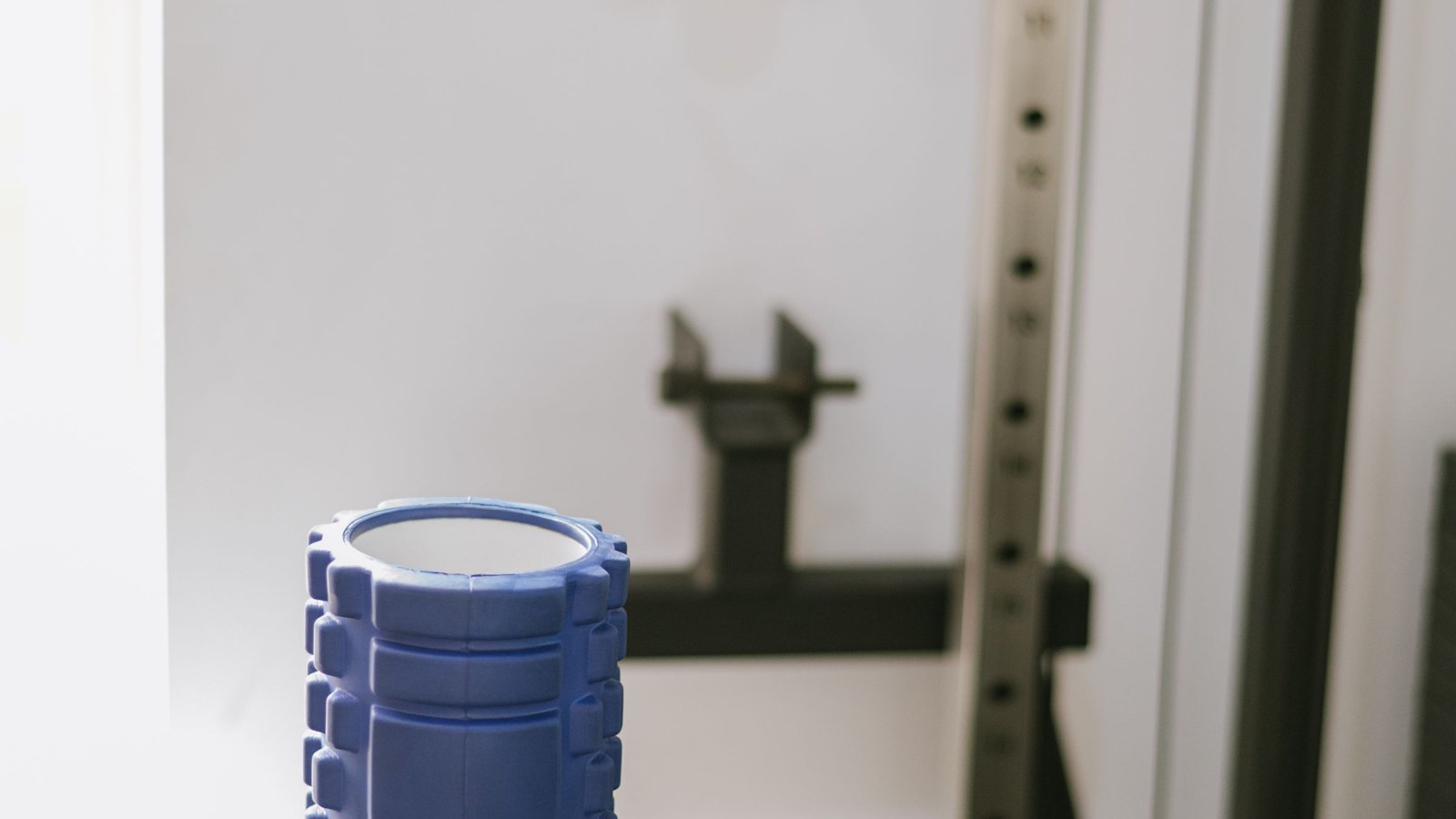 A foam roller standing on a bench in a clinic gym